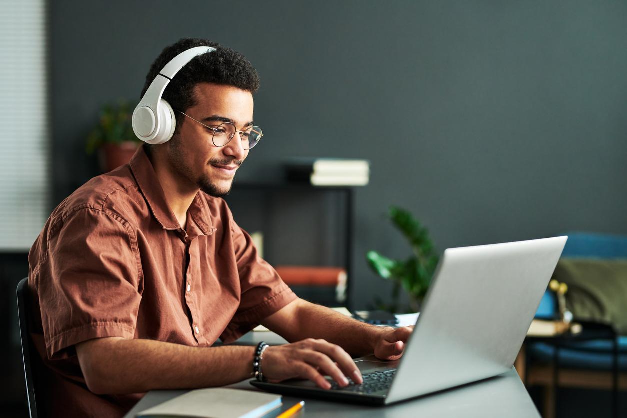 student from final studying at their laptop